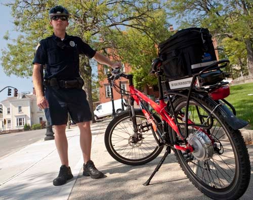 GETTING AROUND: Tony LeDoux, a RISD public safety officer, shows off the electric bicycle the school recently purchased for patrols. / GETTING AROUND: Tony LeDoux, a RISD public safety officer, shows off the electric bicycle the school recently purchased for patrols. /