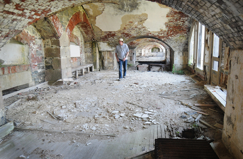 VOTER’S TRUST? Jack McCormack, site manager for the Fort Adams Land Trust, walks through a casemate, which was designed to house cannons. A bond referendum will ask voters to approve $1.5 million for Fort Adams renovations. / VOTER’S TRUST? Jack McCormack, site manager for the Fort Adams Land Trust, walks through a casemate, which was designed to house cannons. A bond referendum will ask voters to approve $1.5 million for Fort Adams renovations. /