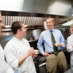 A FINE JOB: Blount Fine Foods employees, from left, Benjamin Murray, Corporate Executive Chef Jeff Wirtz, President Todd Blount and food technologist VJ Bonda in the company’s food-testing room. / 