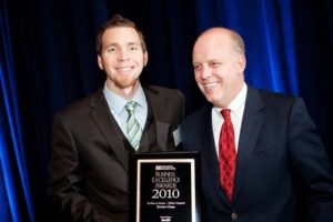 Enviro-Clean CEO, Eric Anderson, accepts the award for Excellence at a Mid-size Company.