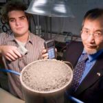 GROUND WORK: URI graduate student Andrew Correia, left, and professor K. Wayne Lee conduct an experiment to measure solar energy generated by asphalt. / 