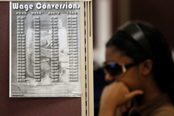 A WOMAN searches for work at the Northside One Stop Career Center in Miami, Fla. Companies in the U.S. boosted payrolls in December by the most since records began in 2001, data from a private report showed on Wednesday. / A WOMAN searches for work at the Northside One Stop Career Center in Miami, Fla. Companies in the U.S. boosted payrolls in December by the most since records began in 2001, data from a private report showed on Wednesday. /