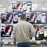 A MAN looks at flat screen televisions inside a BJ's Wholesale Club store in Falls Church, Va. The wholesaler said its board has decided to explore and evaluate strategic options, including a possible sale. / 