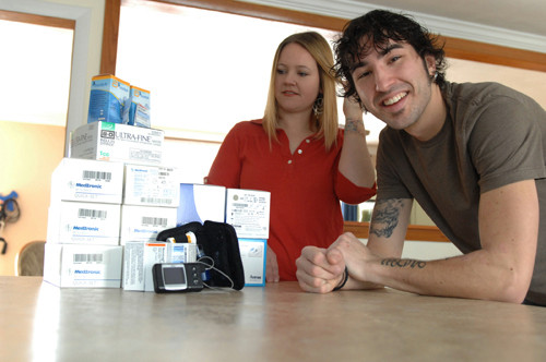 DIRECT SUPPLY: Anna DeMoranville and Alex Jacques in their Warwick home, standing near Jacques’ medication for his Type 1 diabetes. DeMoranville is a Blue Cross & Blue Shield of Rhode Island Direct Pay customer. Jacques left his Direct Pay plan this year. / DIRECT SUPPLY: Anna DeMoranville and Alex Jacques in their Warwick home, standing near Jacques’ medication for his Type 1 diabetes. DeMoranville is a Blue Cross & Blue Shield of Rhode Island Direct Pay customer. Jacques left his Direct Pay plan this year. /