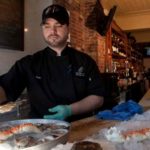 Reviving a near-extinct population LOOKING FOR A PEARL: Providence Oyster Bar employee Ethan Fleming. The restaurant is working with the Nature Conservancy to help rebuild the local wild-oyster stock. /
