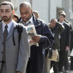 FILE PHOTO: JOB SEEKERS line up outside a career fair. Rhode Island's jobless rate fell in February to 11.2 percent. / 