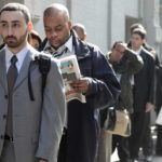 FILE PHOTO: JOB SEEKERS line up outside a career fair. Rhode Island's jobless rate fell in March to 11 percent. / 