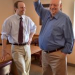 BILL HOFFMAN, right, demonstrates pain-free range of motion after reverse shoulder replacement surgery for his surgeon, Dr. Randall Risinger of South County Orthopedics, left. / 