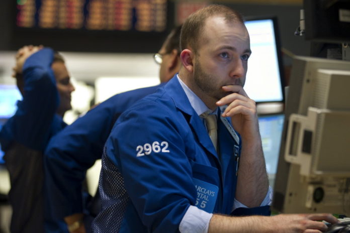 FILE PHOTO: A TRADER works on the floor of the New York Stock Exchange. / FILE PHOTO: A TRADER works on the floor of the New York Stock Exchange. /