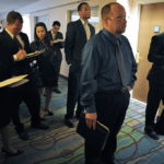 JOB seekers wait to speak to recruiters at the HireLive management and sales job fair in San Diego, Calif., on May 5. Locally, Rhode Island's unemployment rate fell below 11 percent for the first time in almost two years on Friday. / 