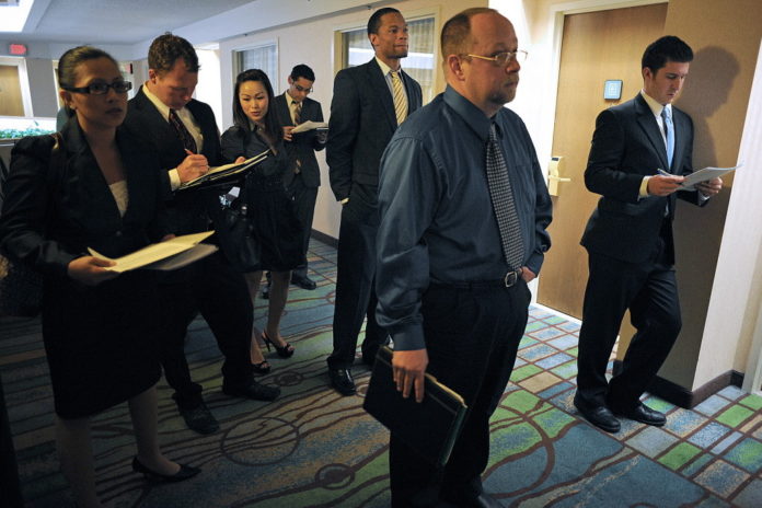 JOB seekers wait to speak to recruiters at the HireLive management and sales job fair in San Diego, Calif., on May 5. Locally, Rhode Island's unemployment rate fell below 11 percent for the first time in almost two years on Friday. / 