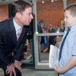 MEETING OF THE MINDS: Hasbro CEO Brian Goldner speaks with Jared Furtado, 8, the company’s youngest shareholder.  At the May 19 Hasbro Inc. annual meeting, shareholders received Transformer figures, My Little Pony toys and a Scrabble card game. / 