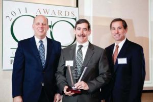 Honoree Thomas Eagan, Partridge Snow & Hahn with PBN Publisher Roger Bergenheim and Mike Caprio, KPMG / Rupert Whitely