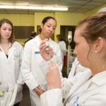 University of Rhode Island students Laura Daley, left, and Liara Silva, center, watch Marisa Santos draw insulin into a syringe, in this 2008 photo. A shared nursing-education facility would include URI and Rhode Island College. / 