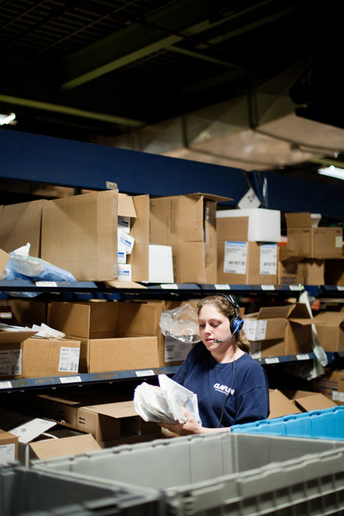 EXCHANGE OF IDEAS: Warehouse associate Diane Cournoyer works at The Claflin Co.'s Warwick facility. Company President Ted Almon says that the cost of health care for employees like Cournoyer is an issue on par with the state's pension crisis. / EXCHANGE OF IDEAS: Warehouse associate Diane Cournoyer works at The Claflin Co.'s Warwick facility. Company President Ted Almon says that the cost of health care for employees like Cournoyer is an issue on par with the state's pension crisis. /