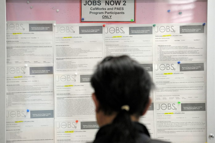 A JOB seeker looks at listings on a bulletin board in the One Stop Career Link Center in San Francisco, Calif. In May, the Rhode Island jobless rate remained unchanged but the state added 1,300 jobs for the month. / 