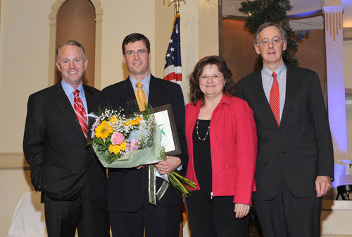 TOM MURPHY, second from left, is presented with Rhode Island Hospital’s inaugural Resident of the Year award by Rhode Island Hospital leaders, remaining, from left: Timothy J. Babineau, president and CEO of Rhode Island Hospital and The Miriam Hospital; Staci Fischer, director of graduate medical education; and John Murphy, senior vice president and chief medical officer. / TOM MURPHY, second from left, is presented with Rhode Island Hospital’s inaugural Resident of the Year award by Rhode Island Hospital leaders, remaining, from left: Timothy J. Babineau, president and CEO of Rhode Island Hospital and The Miriam Hospital; Staci Fischer, director of graduate medical education; and John Murphy, senior vice president and chief medical officer. /