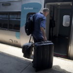 A PASSENGER boards an Amtrak Acela passenger train at Union Station in Washington D.C. / 