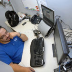 NO TROUBLE: Warwick-based PC Troubleshooters has become a mainstay on PBN's Fastest Private Growing Companies list. Pictured above is Carlos Aldana, the company's director of remote service. / PBN PHOTO/BRIAN MCDONALD