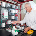 ON THE GRID: Jerry Bernardini, chairman of the Engineering and Technology Department at CCRI, demonstrates some of the new equipment that will be used in a joint program offered by the school and National Grid. / PBN PHOTO/NATALJA KENT