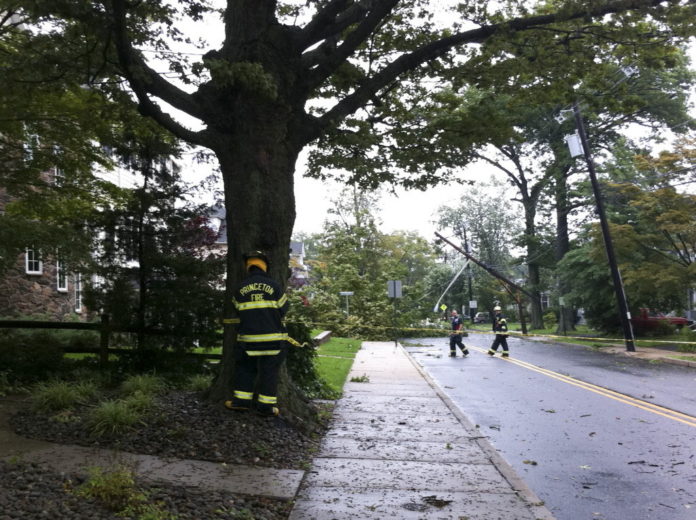Fire department officials attend to a downed power pole in Princeton, N.J. / BLOOMBERG NEWS PHOTO JOHN MCCORRY Fire department officials attend to a downed power pole in Princeton, N.J. / BLOOMBERG NEWS PHOTO JOHN MCCORRY