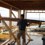 Barrington contractor to share TV spotlight NEW AGAIN: Andrew Tiplady carries refuse from the demolition phase of a project that will be featured on "This Old House." / PBN PHOTO/BRIAN MCDONALD