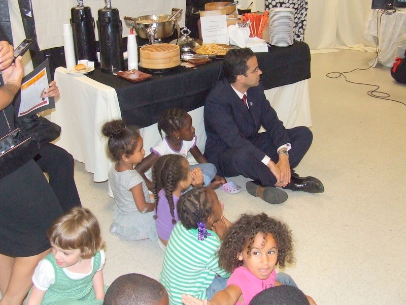 Providence's Mayor Taveras sits with children at the Federal Hill House' open house for its language learning-program. Providence's Mayor Taveras sits with children at the Federal Hill House' open house for its language learning-program.