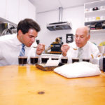 SOMETHING BREWING: Excellent Coffee Co. Vice President Mike Kapos, left, and President and CEO William Kapos, at their Pawtucket facility. William Kapos said that Donald R. Grebien is the first sitting mayor to visit the company in decades. / PBN PHOTO/BRIAN MCDONALD