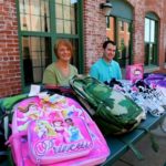 CAROL WRIGHT, payroll accountant at Collette Vacations, and Chris Cahill, programmer at Collette Vacations, display the supplies collected for the Granja Hogar boarding school through Collette Foundation’s Mexico Task Force.