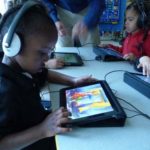 COURTESY HIGHLANDER CHARTER SCHOOLRIGHT TOUCH: Highlander Charter School student Camren Perry uses one of the school's touch-screen tablets, a tool used in Highlander's class instruction.