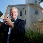 LOUD AND CLEAR: Bob Burke, in front of Providence&rsquo;s historic First Baptist Church, a stop along the Independence Trail he created. The trail is marked by a painted, green line along the sidewalk that visitors can follow, using cellphones to access information on each stop. / PBN PHOTO/RUPERT WHITELEY