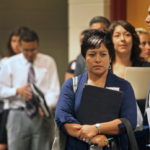 JOB SEEKER Judith Meza Vazquez, second right, waits in line to have her resume reviewed at a career enhancement conference. / BLOOMBERG NEWS FILE PHOTO TIM BOYLE
