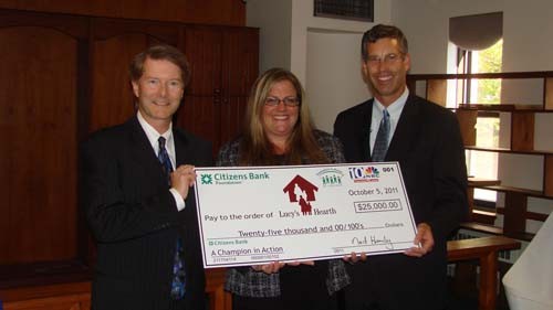 JENNIFER BARRERA, center, program director for Lucy’s Hearth, is presented with a $25,000 grant by Vic Vetters, left, vice president and general manager for WJAR-TV NBC 10, and Ned Handy, president of Citizens Bank Rhode Island and Connecticut, after Lucy’s Hearth was named a Champion in Action. JENNIFER BARRERA, center, program director for Lucy’s Hearth, is presented with a $25,000 grant by Vic Vetters, left, vice president and general manager for WJAR-TV NBC 10, and Ned Handy, president of Citizens Bank Rhode Island and Connecticut, after Lucy’s Hearth was named a Champion in Action.