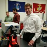 This firm is gold standard in equipment tracking RIGHT ON TRACK: A2B Tracking Solutions President Peter Collins works alongside Tim Collins, green shirt, and Beck Bennett, red shirt. The company does work for the Department of Defense and leading companies in the education and financial-services fields. / PBN PHOTO/MICHAEL PERSSON