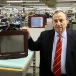 MAD DASH: Everett V. Pizzuti, president and CEO of Astro-Med Inc., stands beside his company&rsquo;s new product, the Dash MX. / PBN PHOTO/MICHAEL PERSSON