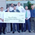 FROM LEFT: Hemenway’s Seafood Grill & Oyster Bar  employees Elser Ramirez, sous chef,; Katie McBride, sales manager; Mark Smith, raw bar attendant; Dean Pacheo, manager; Steve Long, executive chef; and Tobey Sanborn, senior general manager; present a $7,268 donation to Michael Fantom, executive director, Ronald McDonald House of Providence.
