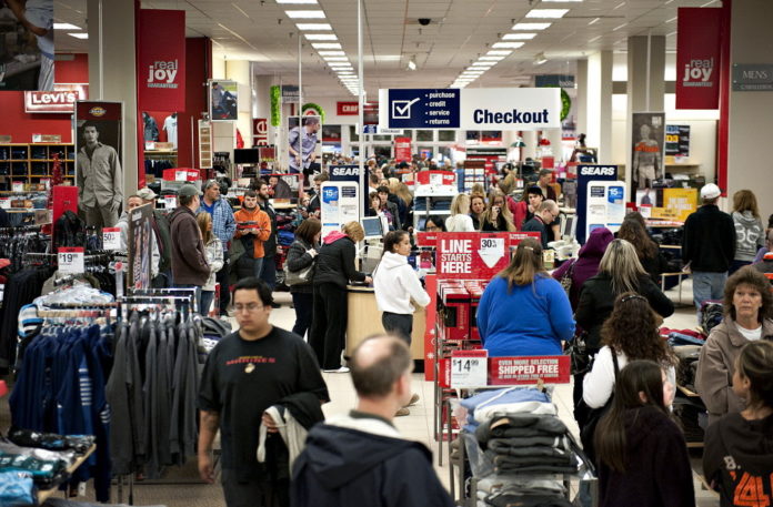 SHOPPERS browse merchandise in a Sears store at Simon Property Group Inc.'s Great Lakes Mall in Mentor, Ohio. Black Friday, traditionally the biggest U.S. shopping day of the year, got off to its earliest start ever as retailers tried to woo shoppers with discounts and early store openings.  / COURTESY BLOOMBERG NEWS FILE PHOTO DANIEL ACKER