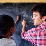 Helping donors connect to students in need COURTESY THE SCHOOL FUND
LESSONS LEARNED: Brown University graduate Matt Severson, right, works on a math problem with student Apollo Hando in a classroom in the United Republic of Tanzania.