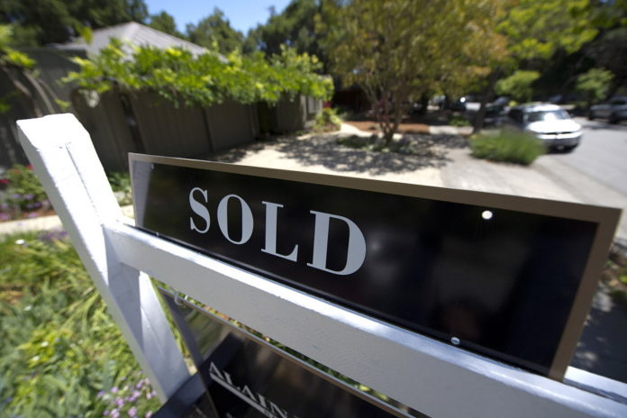 RHODE Island single-family home sales rose six percent in November, but the median price declined 8 percent compared with the same period a year ago, the Rhode Island Association of Realtors said Tuesday. / BLOOMBERG NEWS FILE PHOTO DAVID PAUL MORRIS