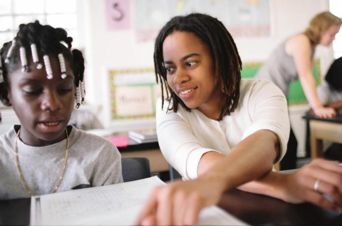 A MIDDLE school principal in Washington D.C. works with a student. Rhode Island ranked 20th on this year's Quality Counts education report. / BLOOMBERG NEWS FILE PHOTO