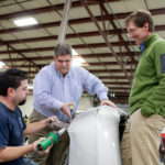 Firm eyes profit in plastic welding WORLDS COLLIDE: From left: Carl's Collision Center technician Carlos Rodriguez, owner Carl Garcia and Malcom Technologies President Jonathan Bixby demonstrate Malcom's automotive bumper-repair kit. Carl's is a partner in the venture. / PBN PHOTO/RUPERT WHITELEY