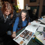 BOUNCING BACK: Le Moulin owner Marie Deschenes, seated, shows her niece, Anne Escalante, ideas for the renovation of the complex generated by students at Roger Williams University. / PBN PHOTO/BRIAN MCDONALD