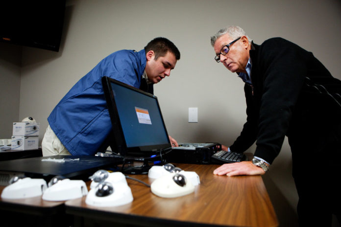 EMERGING MARKETS: Shanix Technology technical specialist Michael Lewis, left, and General Director Don Volino at the company's Cranston headquarters. The security and audio-visual dealer has moved into the education-technology market. / PBN PHOTO/RUPERT WHITELEY
