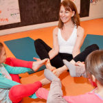 Flexibility helps in business, yoga HITTING THE MAT: Om Kids Yoga Center owner Elyse Rotondo instructs daughters Scarlet Rotondo, left, and Lola Rotondo in her Pawtucket studio. Elyse Rotondo is a former fashion executive who switched to teaching, eventually opening the studio last year. / PBN PHOTO/NATALJA KENT