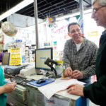 NAILING IT: Mount Pleasant Hardware owner Marc Gillson, center, talks with office manager Anne Andrade and customer Bill Woods. The company was started by Gillson's grandfather in 1923. / PBN PHOTO/RUPERT WHITELEY