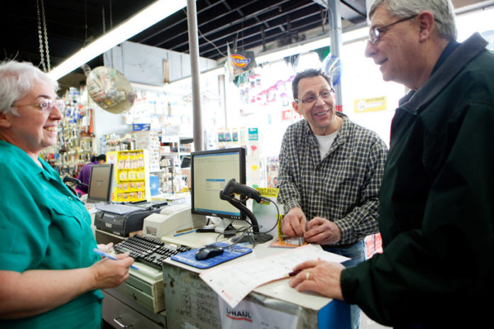 NAILING IT: Mount Pleasant Hardware owner Marc Gillson, center, talks with office manager Anne Andrade and customer Bill Woods. The company was started by Gillson's grandfather in 1923. / PBN PHOTO/RUPERT WHITELEY