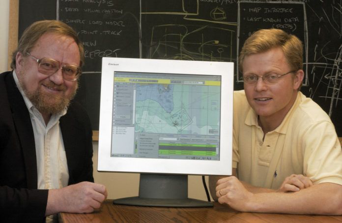 MALCOLM SPAULDING, left, is retiring from the University of Rhode Island after 39 years there. A pioneer in tracking ocean oil spills and their effects, he founded Applied Science Associates to model spills; he is shown here with company CEO Eoin Howlett in a 2007 photo. / COURTESY URI