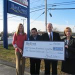 ANGELA DAWICKI of the Bicentennial Committee and Wayne Oliveira, Chairman of the Bicentennial Committee, receive a $5,000 check from BayCoast Bank Branch Manager Kevin Melo and Regional Branch Manager Paula Freitas. / COURTESY BANKFIVE