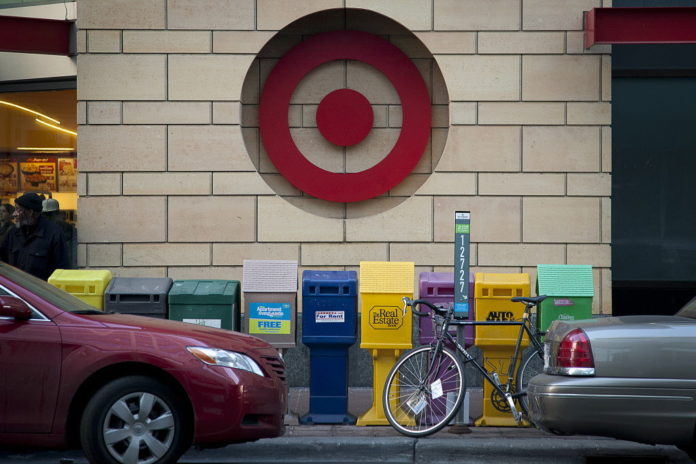 CARS sit parked in front of Target Corp. signage displayed outside of a store in Minneapolis, Minnesota / BLOOMBERG NEWS FILE PHOTO ARIANA LINDQUIST