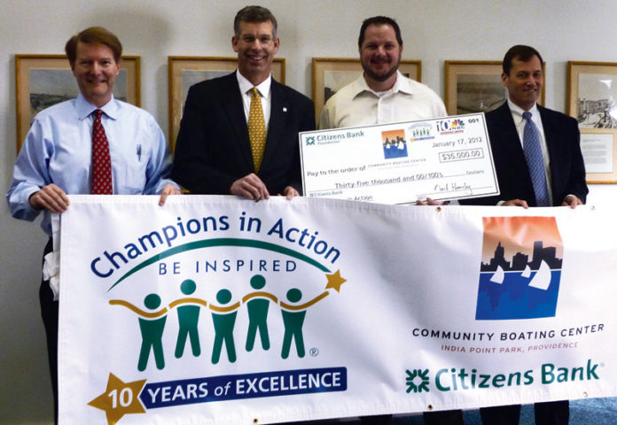 JOHN O’FLAHERTY, second from right, executive director of Community Boating Center, was presented with a $35,000 grant by representatives of Citizens Bank and WJAR-TV NBC 10, who recently named the Center a Champion in Action. Remaining, from left: Vic Vetters, vice president and general manager for NBC 10; Ned Handy, president, Citizens Bank Rhode Island & Connecticut; and Mike Kennally, senior vice president at Citizens Bank and Community Boating Center board member.